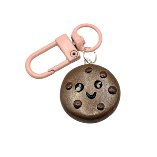 Cookie-shaped keychain with a pink clip on a white background