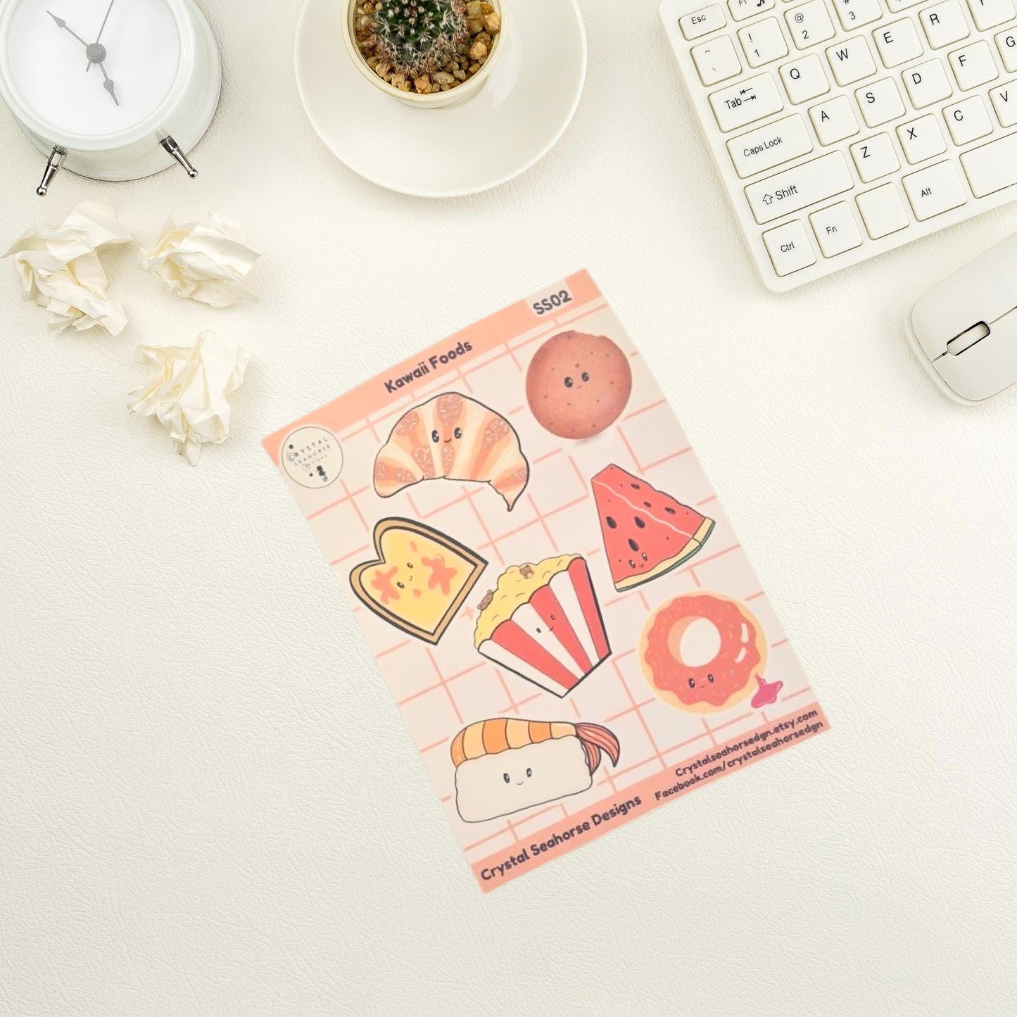 Pack of cute food-themed stickers on a desk with a keyboard and mouse.