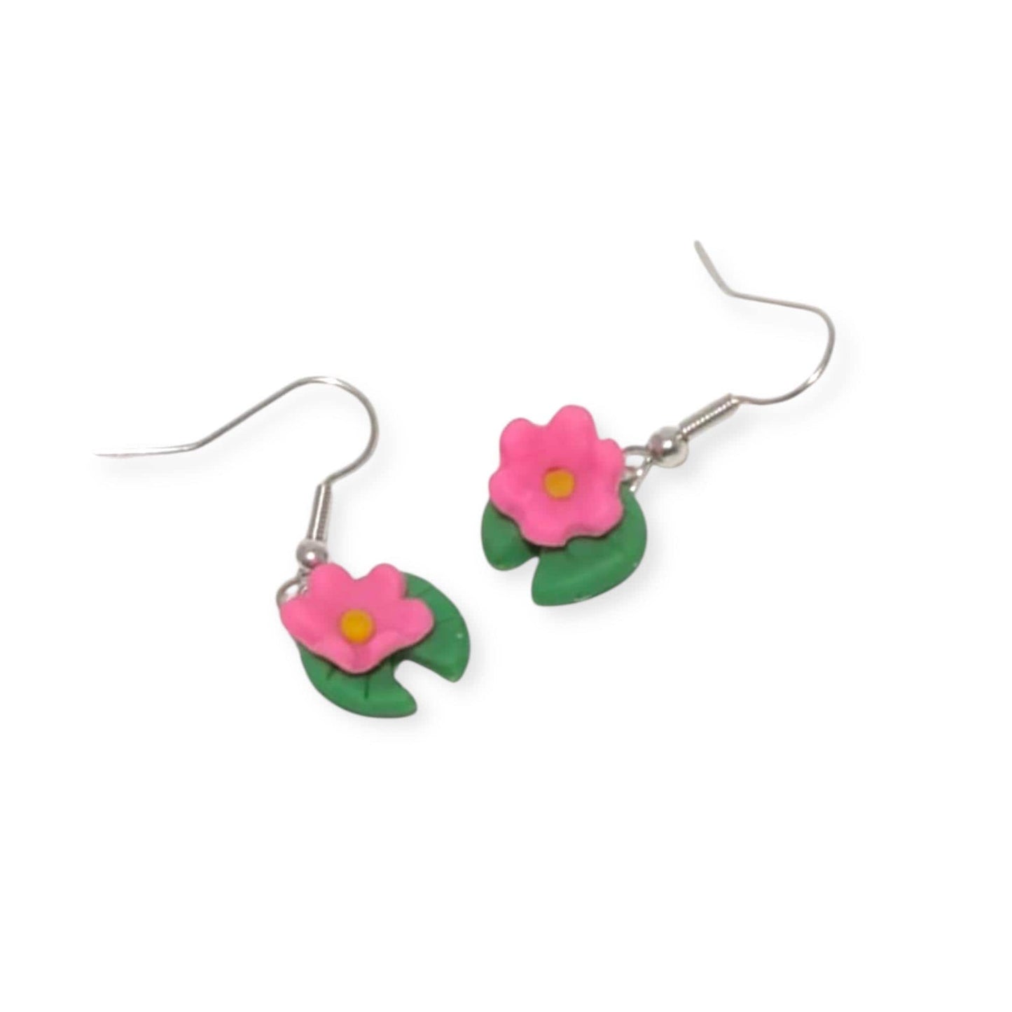 Flower-shaped earrings with pink flowers and green leaves on a white background