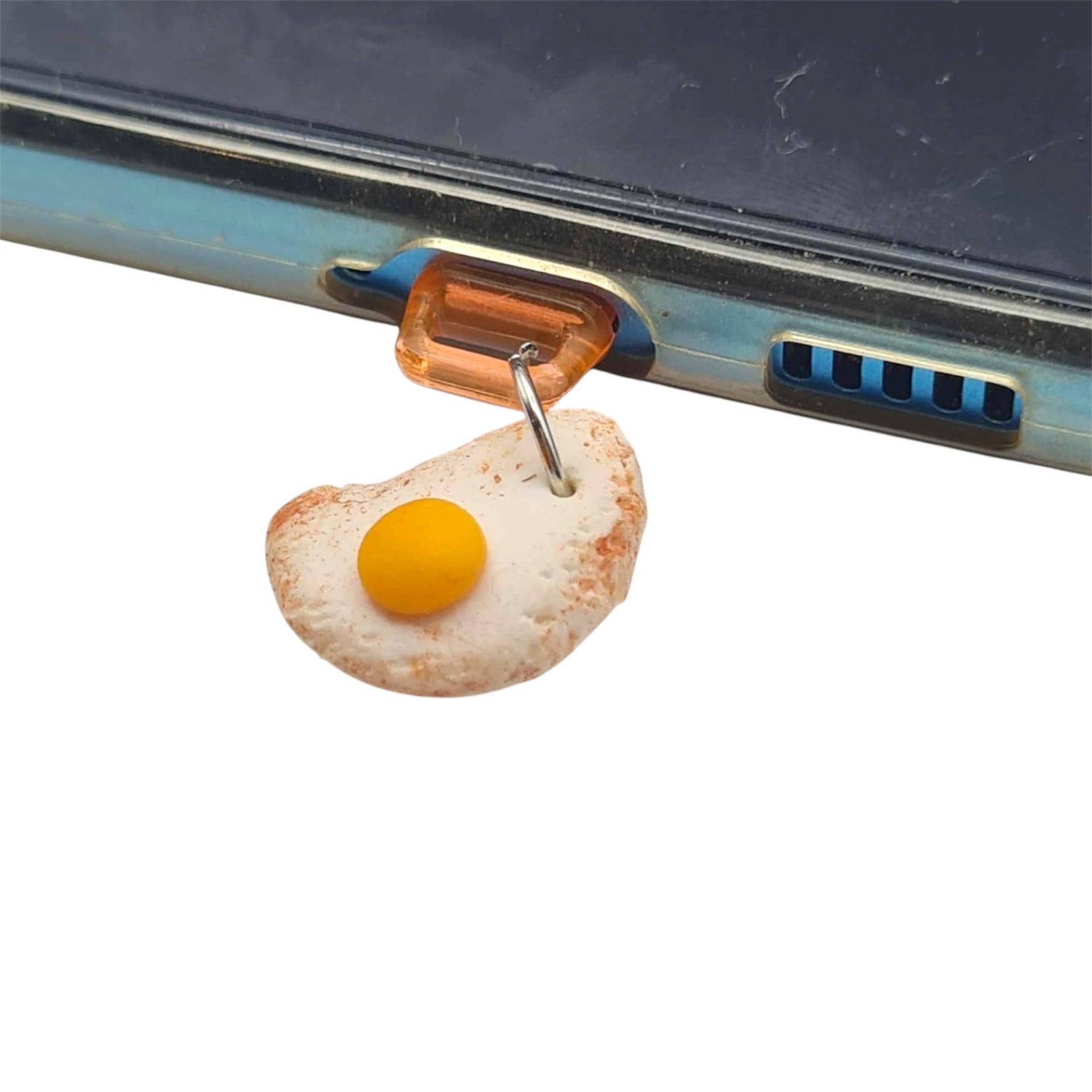 Phone charger with a fried egg-shaped plug attached to a smartphone.