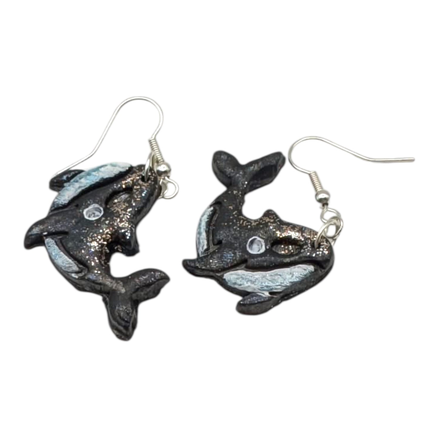 Dolphin-shaped earrings on a white background