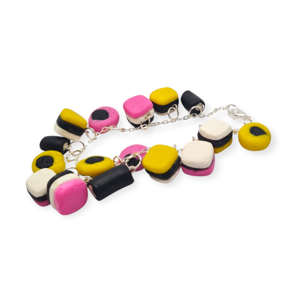 Colourful  bracelet with round and square beads on a white background