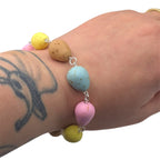 Mini egg bracelet worn on wrist 