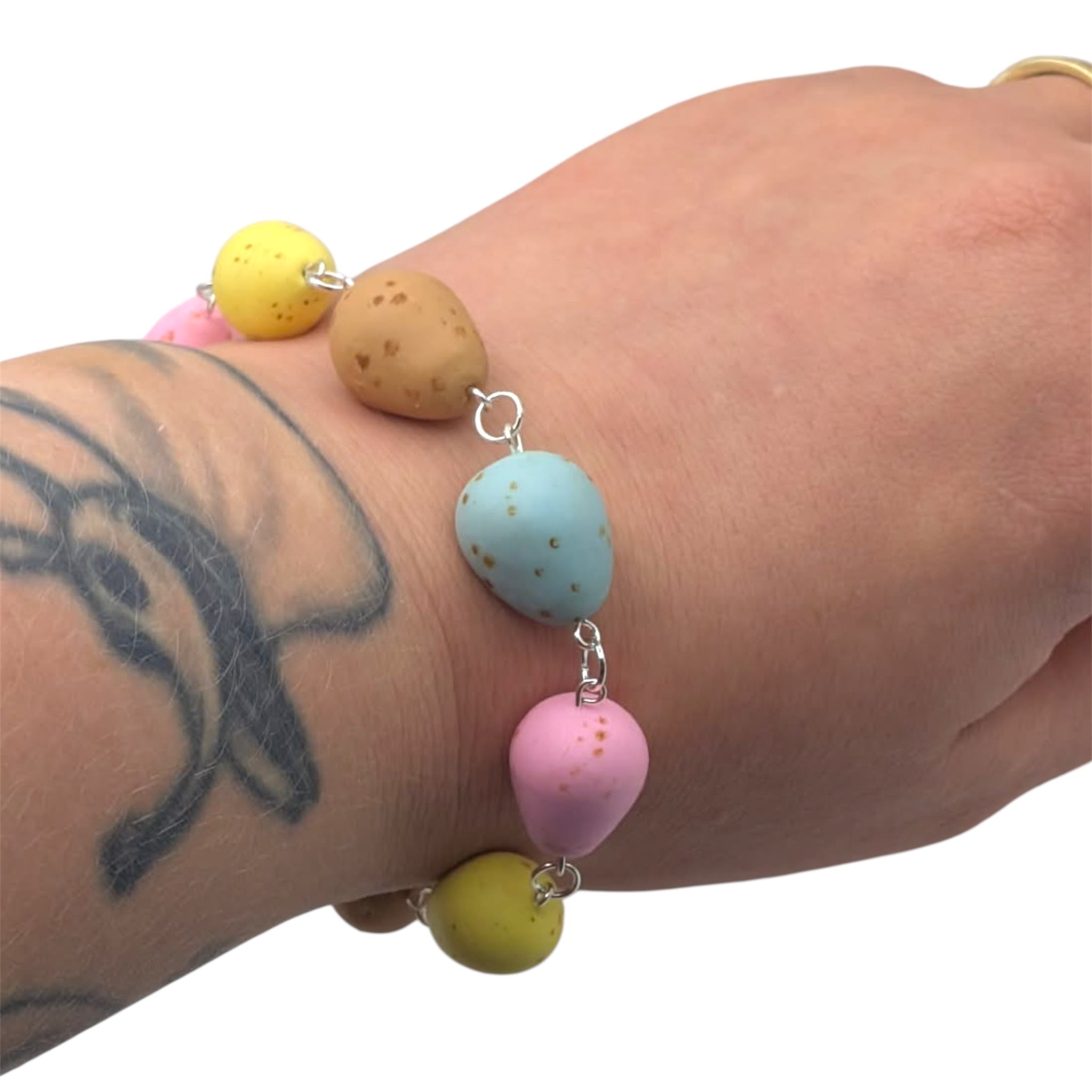 Mini egg bracelet worn on wrist 