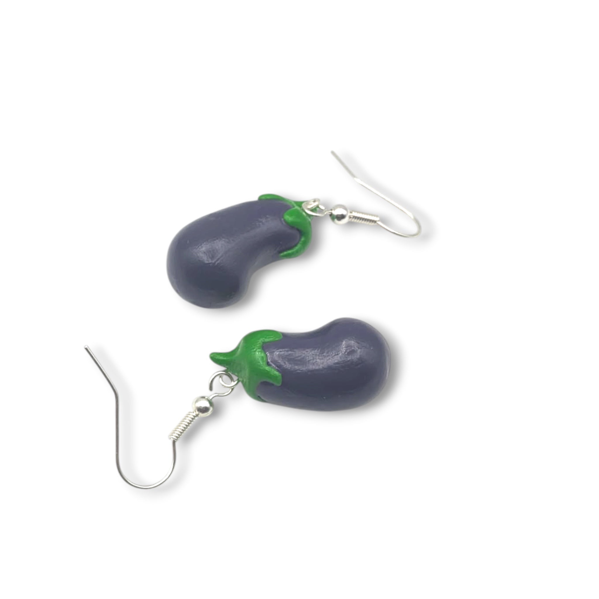Eggplant-shaped silver earrings on a white background