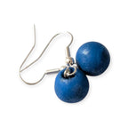 Blue round earrings on silver hooks against a white background