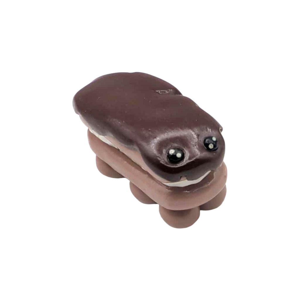 Brown eclair shaped ornament on a white background