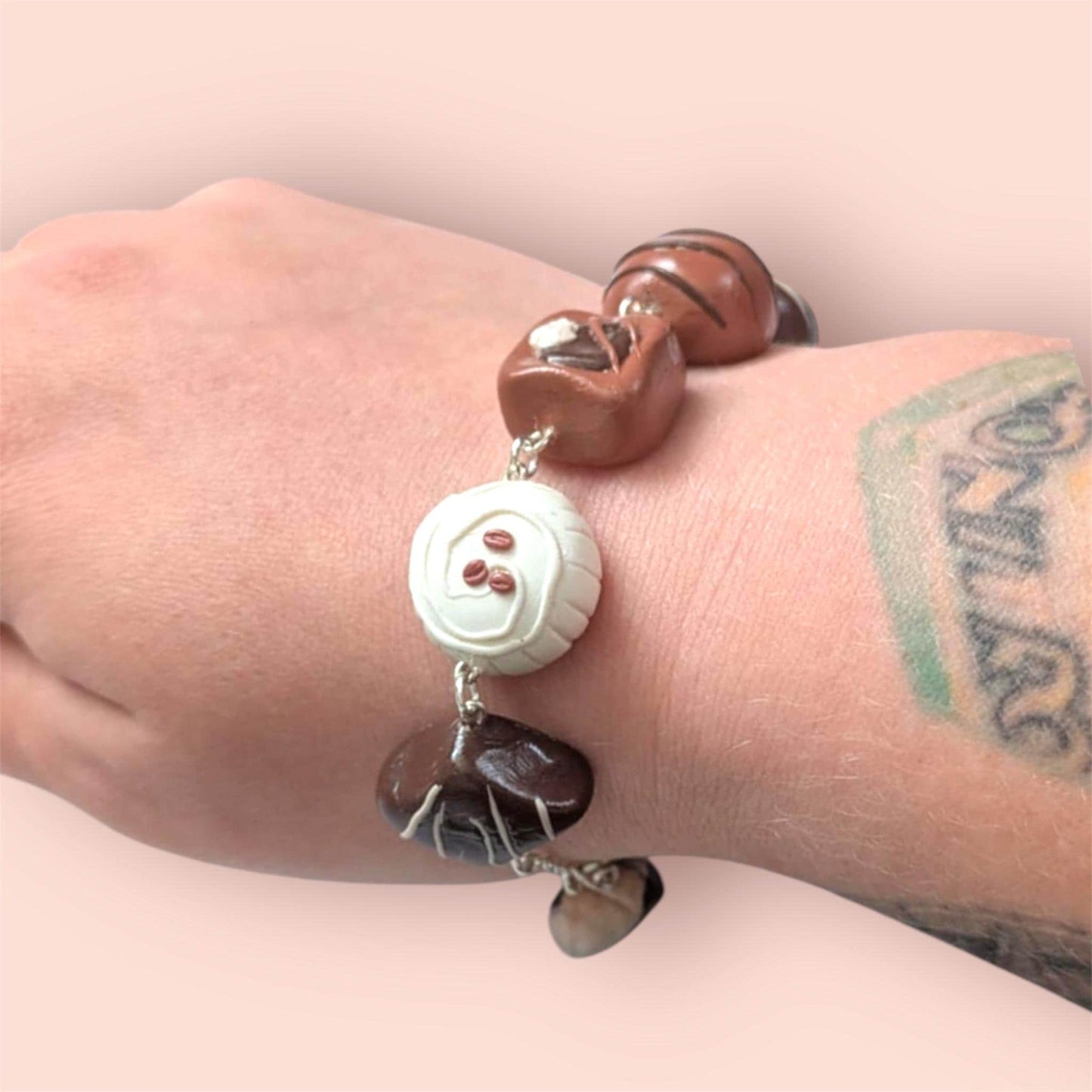Bracelet with brown and white beads on a wrist against a light background