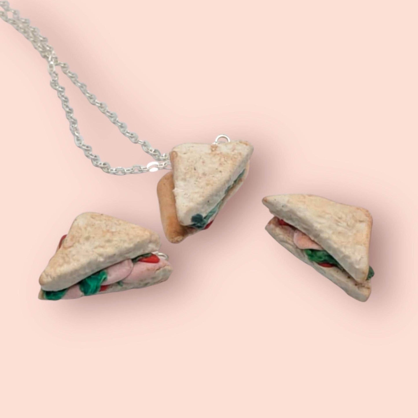 Necklace with sandwich-shaped pendants on a pink background