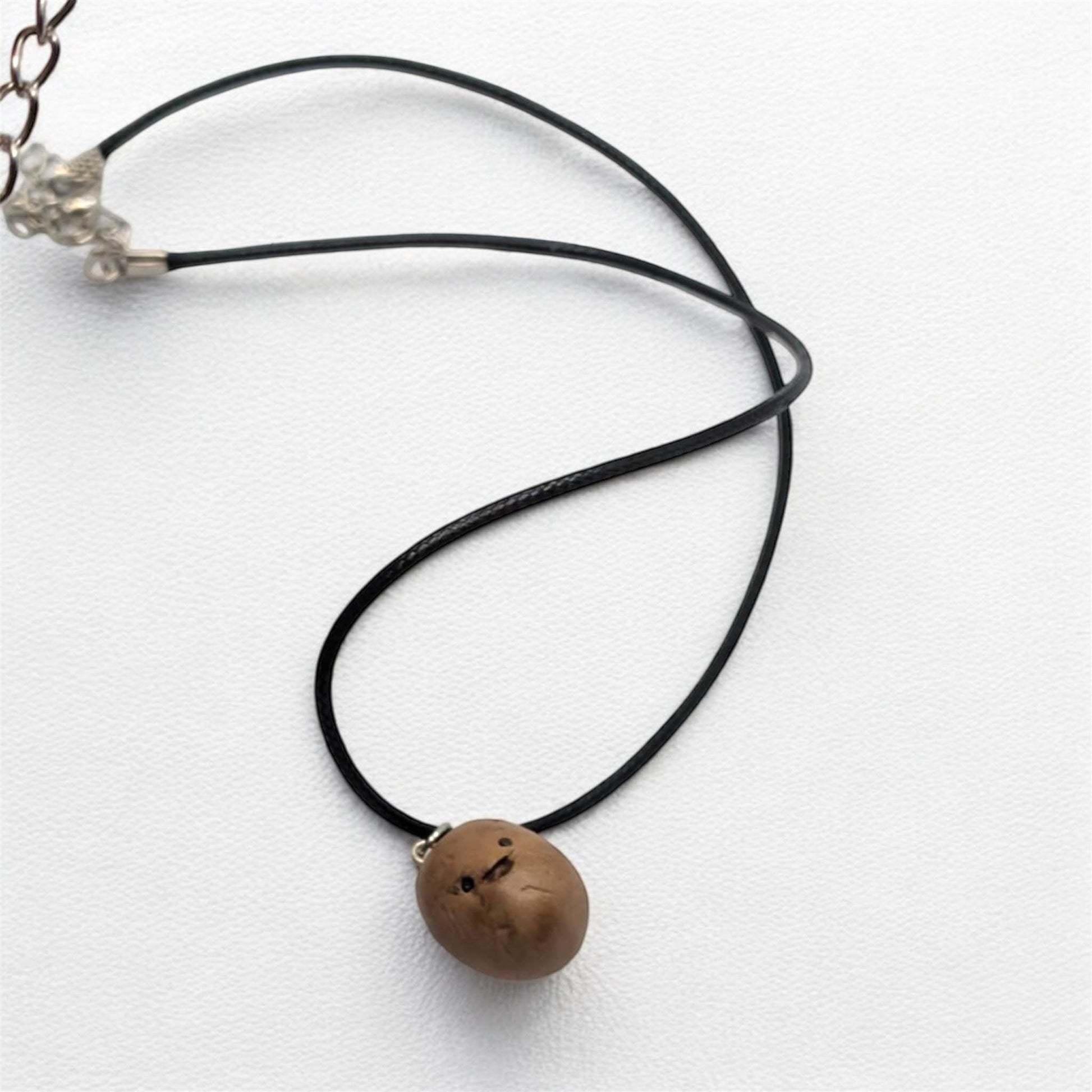Necklace with a brown spud pendant on a white background