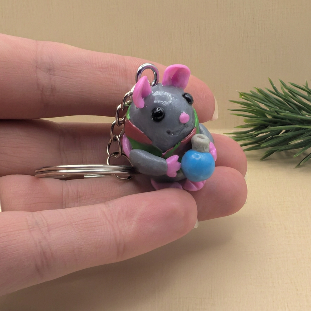 Christmas mouse keyring held in hand with a festive design, perfect cute Christmas gift.