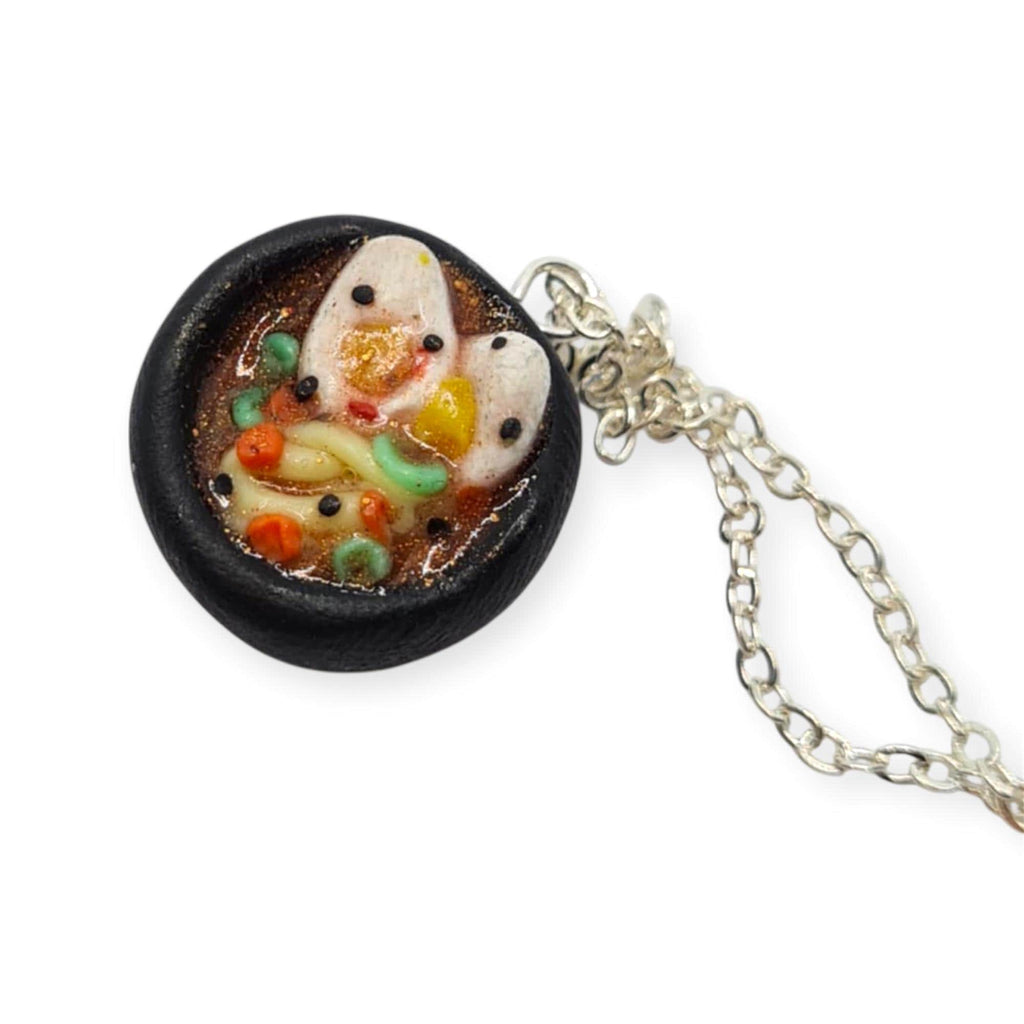 Small round pendant with a chain on a white background
