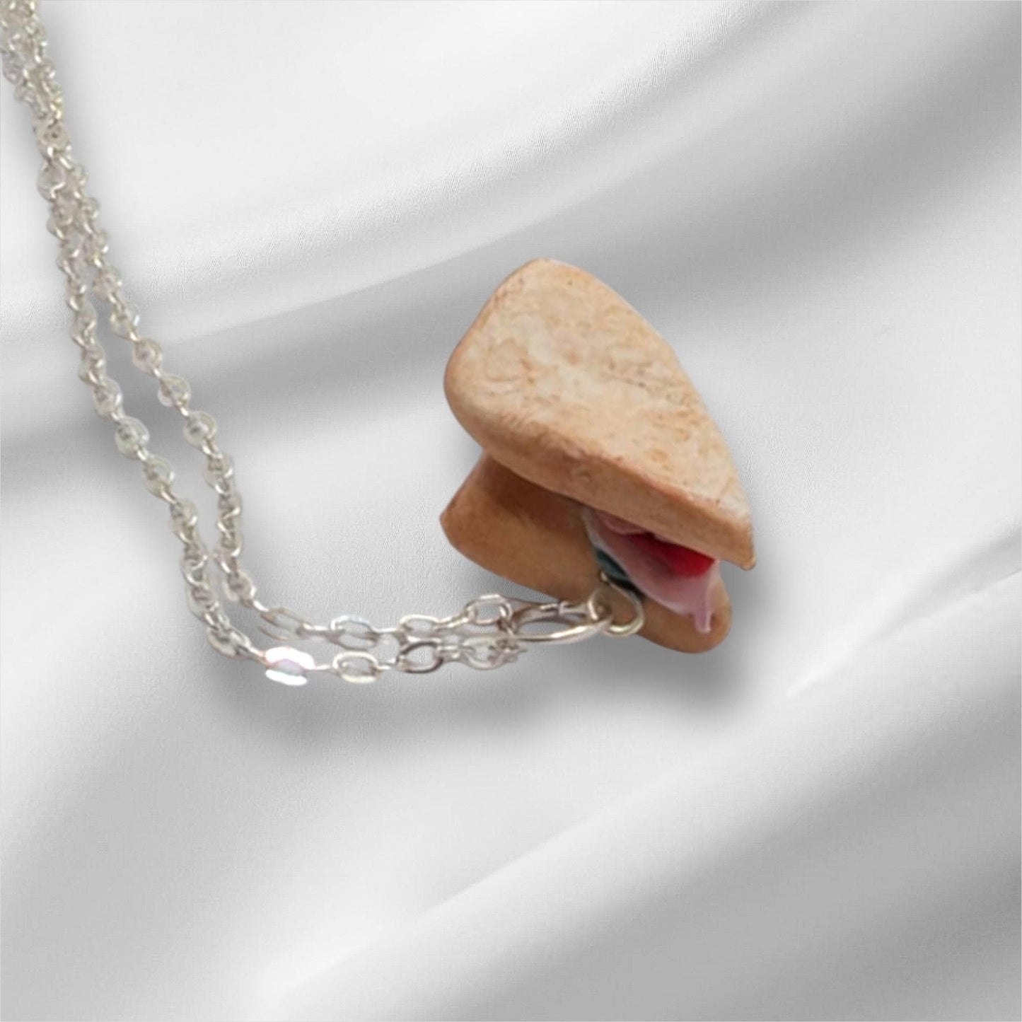 Necklace with a unique pendant on a white fabric background