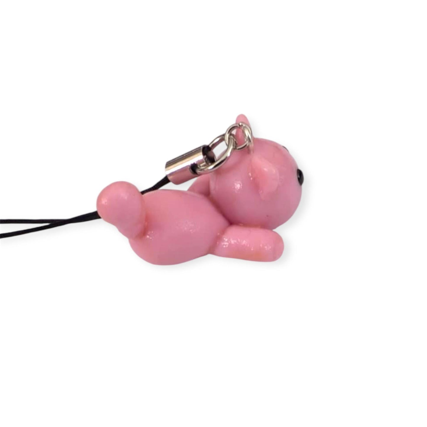 Pink cat-shaped phone charm on a white background