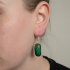 Close-up of polymer clay pickle earring worn on ear, handmade kawaii food jewellery UK