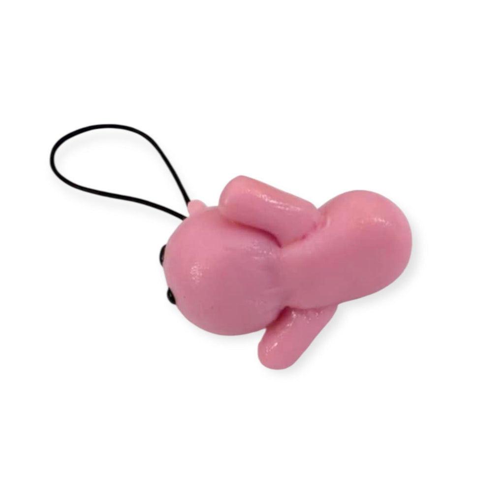 Pink cat shaped keychain on a white background