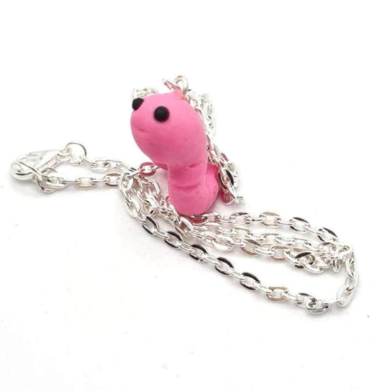 Pink worm-shaped pendant with a silver chain on a white background