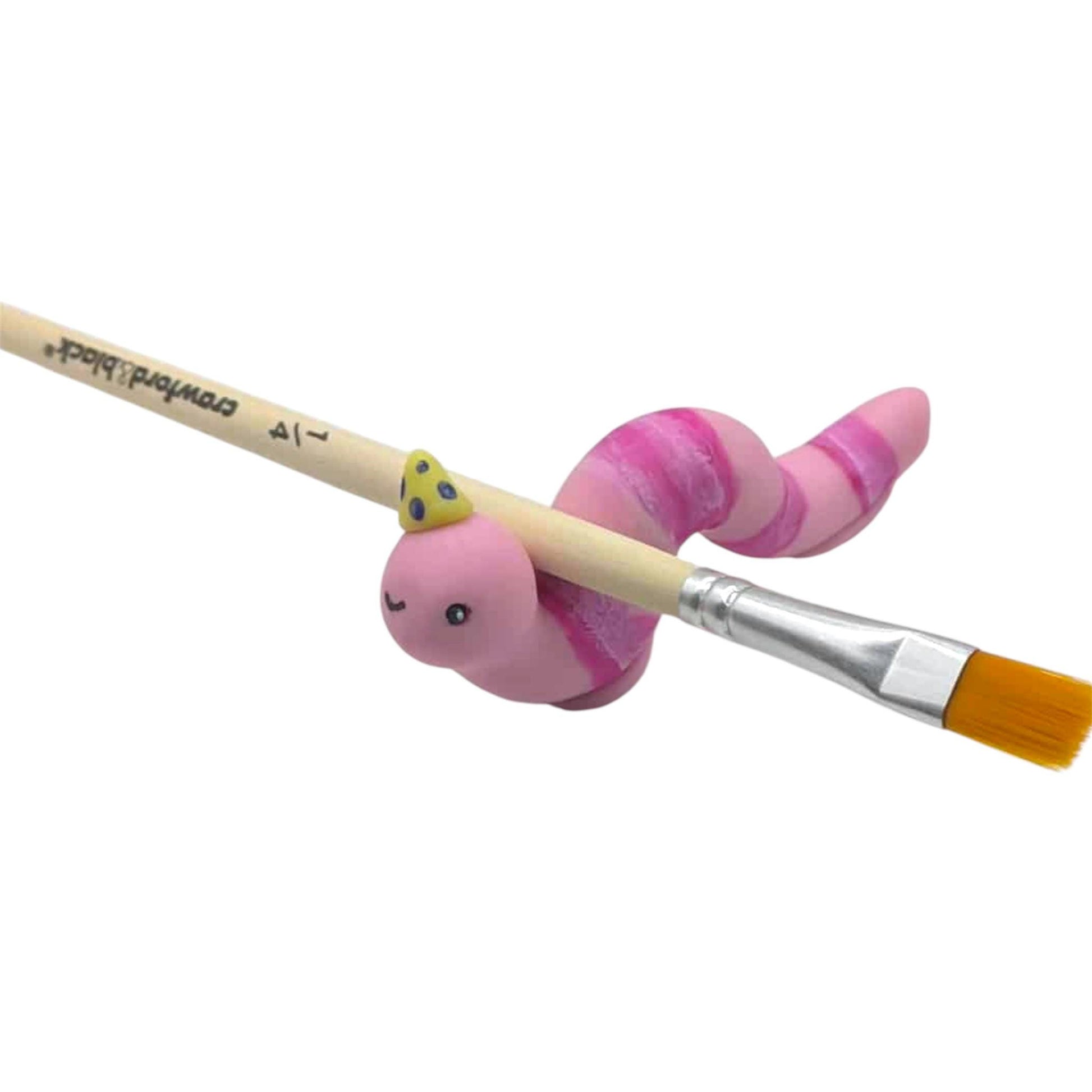 Paintbrush with a pink caterpillar-shaped ornament on a white background
