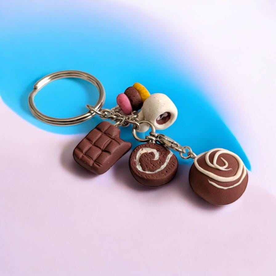 Keychain with chocolate-themed charms on a gradient background