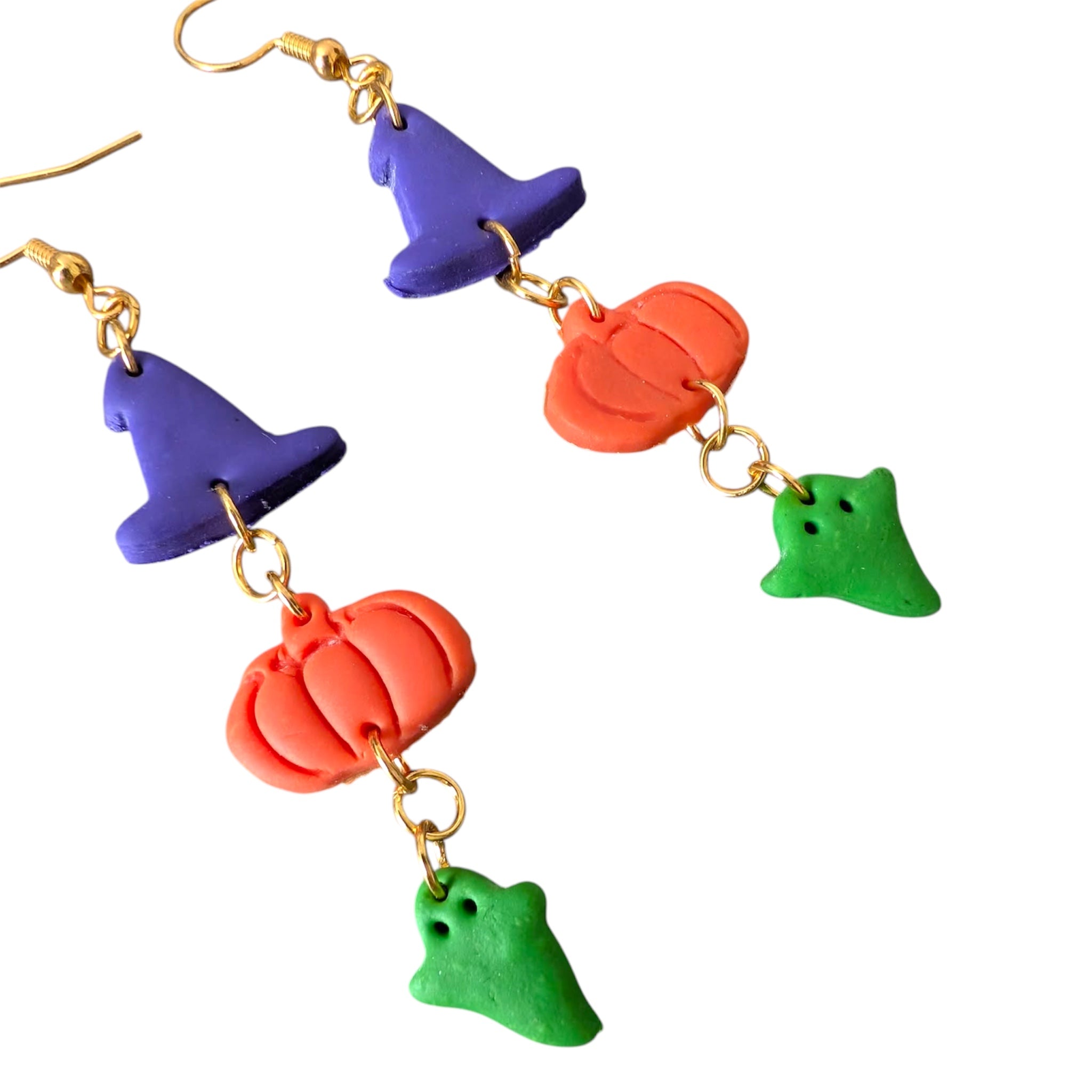 Colorful Halloween-themed earrings with witch hats, pumpkins, and ghosts on a white background.