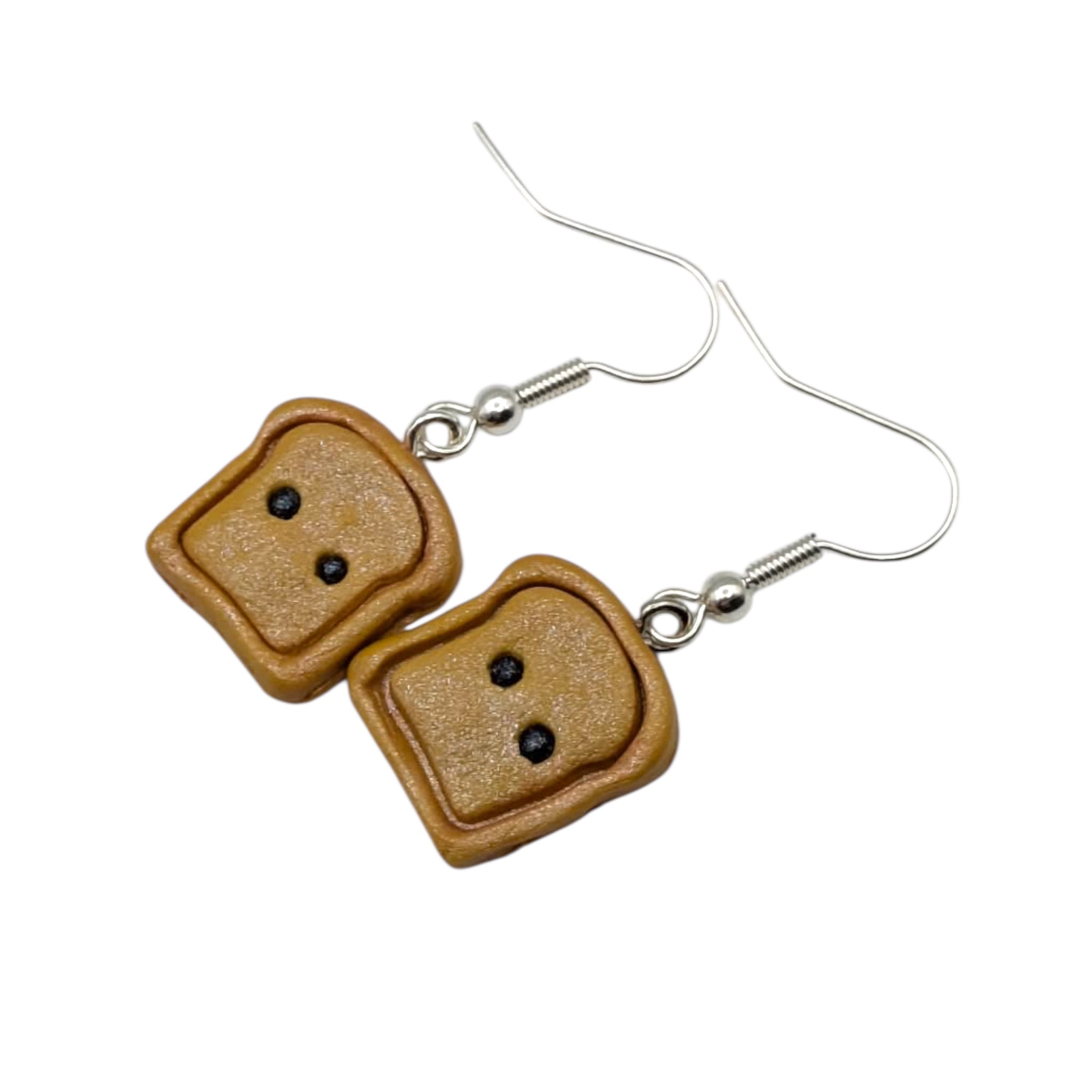 Kawaii handmade polymer clay toast earrings with silver hooks on white background
