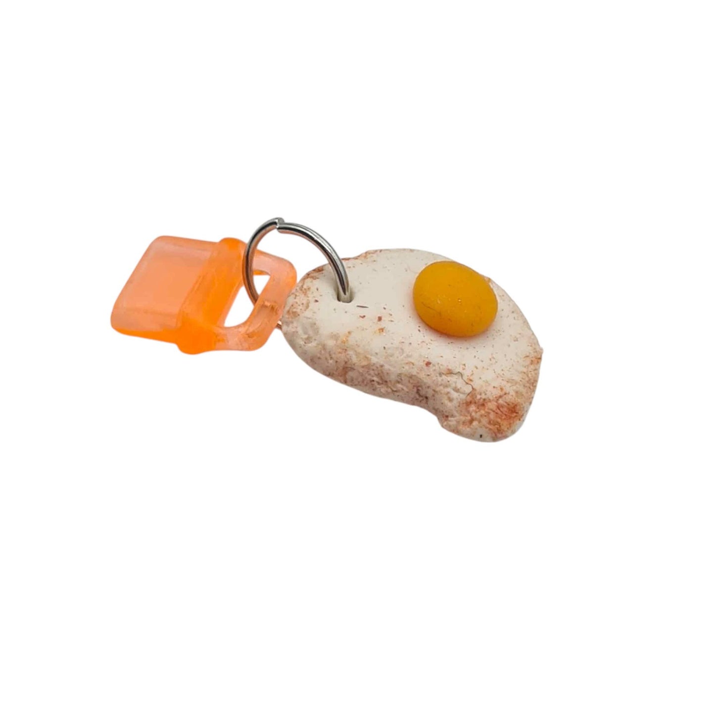 Fake food fried egg charm on a white background