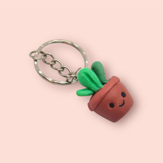 Keychain with a cute potted cactus design on a pink background