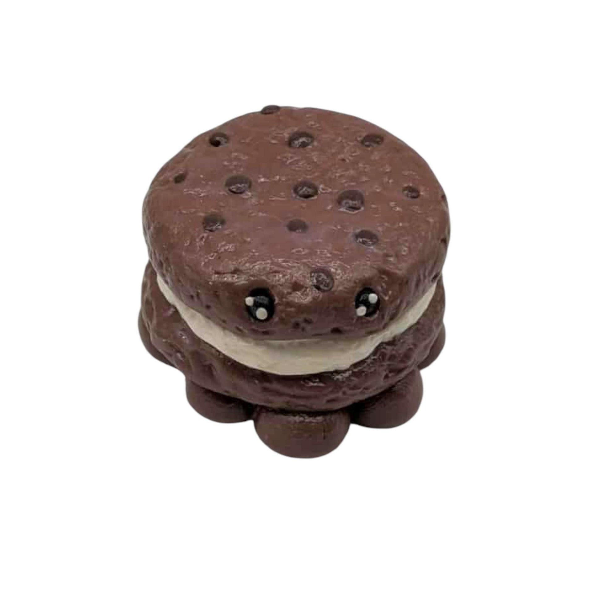 Chocolate cookie with a white filling on a white background