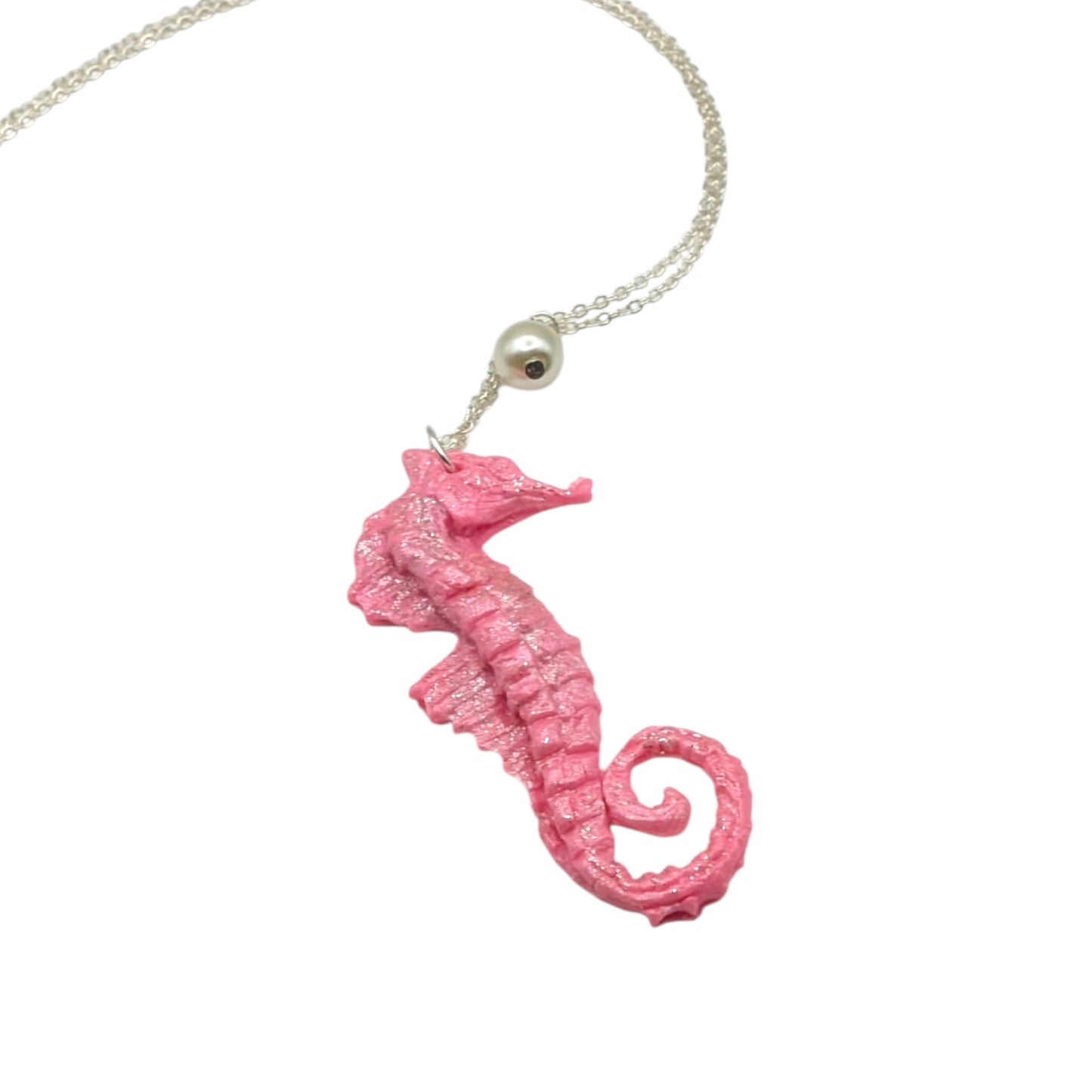 Pink sparkly seahorse pendant necklace with 18-inch silver chain on white background