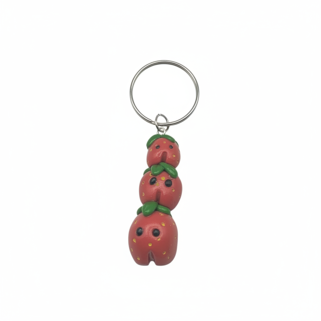 Keychain with three strawberry-shaped beads on a white background