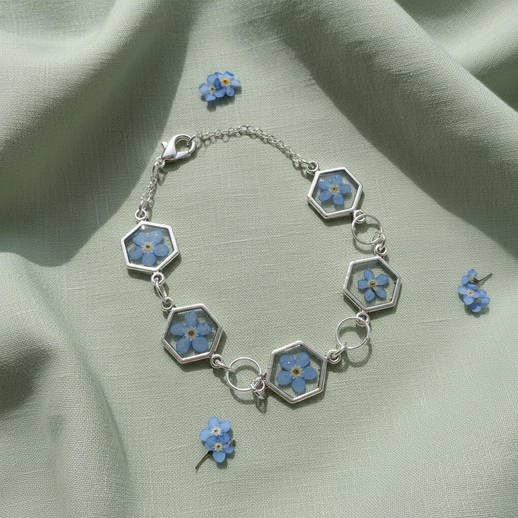 Blue forget me not bracelet with hexagon shaped windows with clear resin and a single pressed flower inside. 