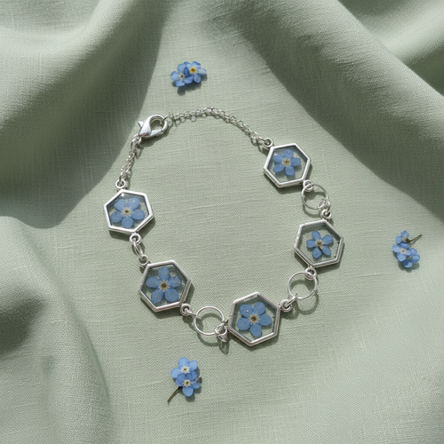 Blue forget me not bracelet with hexagon shaped windows with clear resin and a single pressed flower inside. 