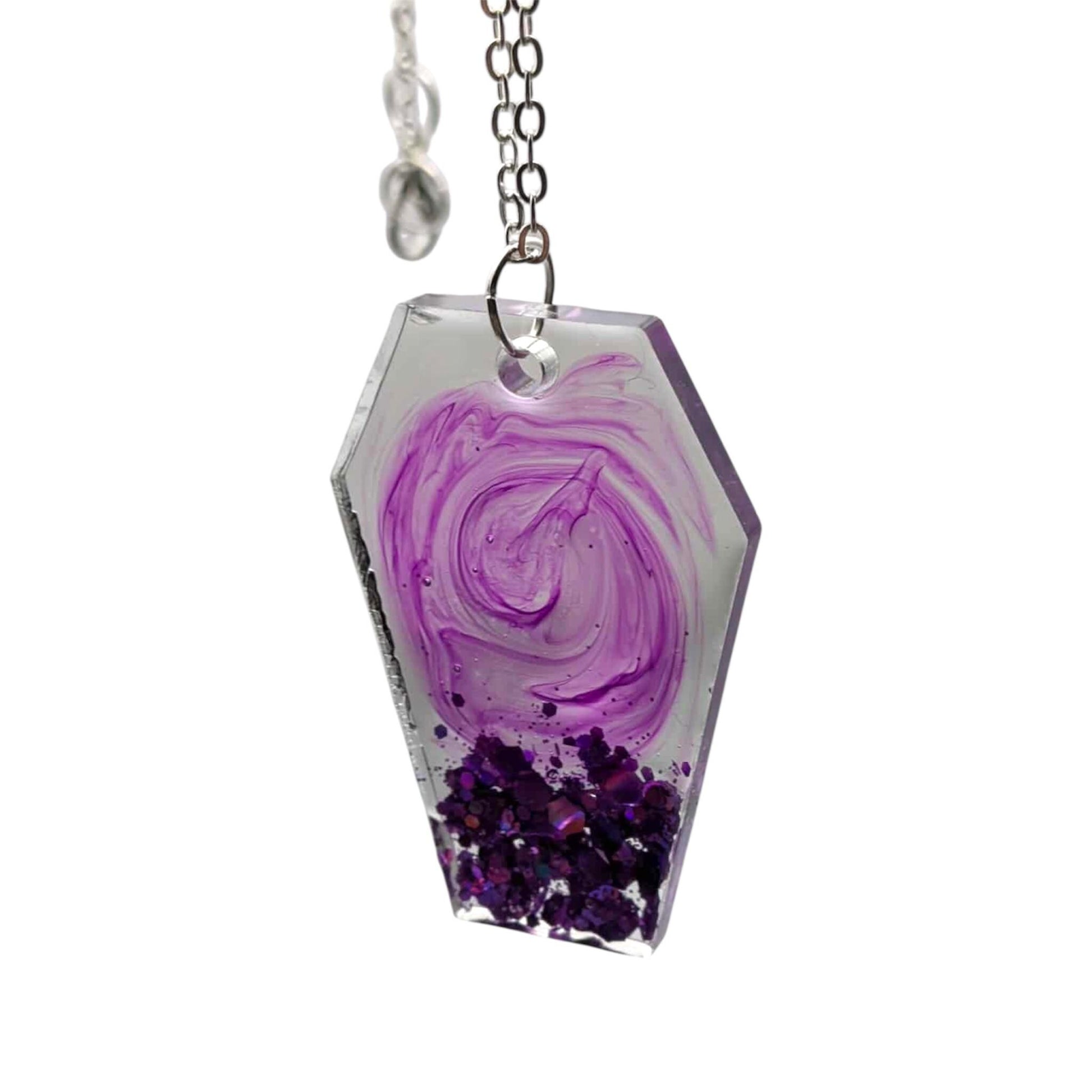 Necklace with a pendant featuring a purple swirl design on a white background