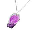 Necklace with a purple pendant on a white background
