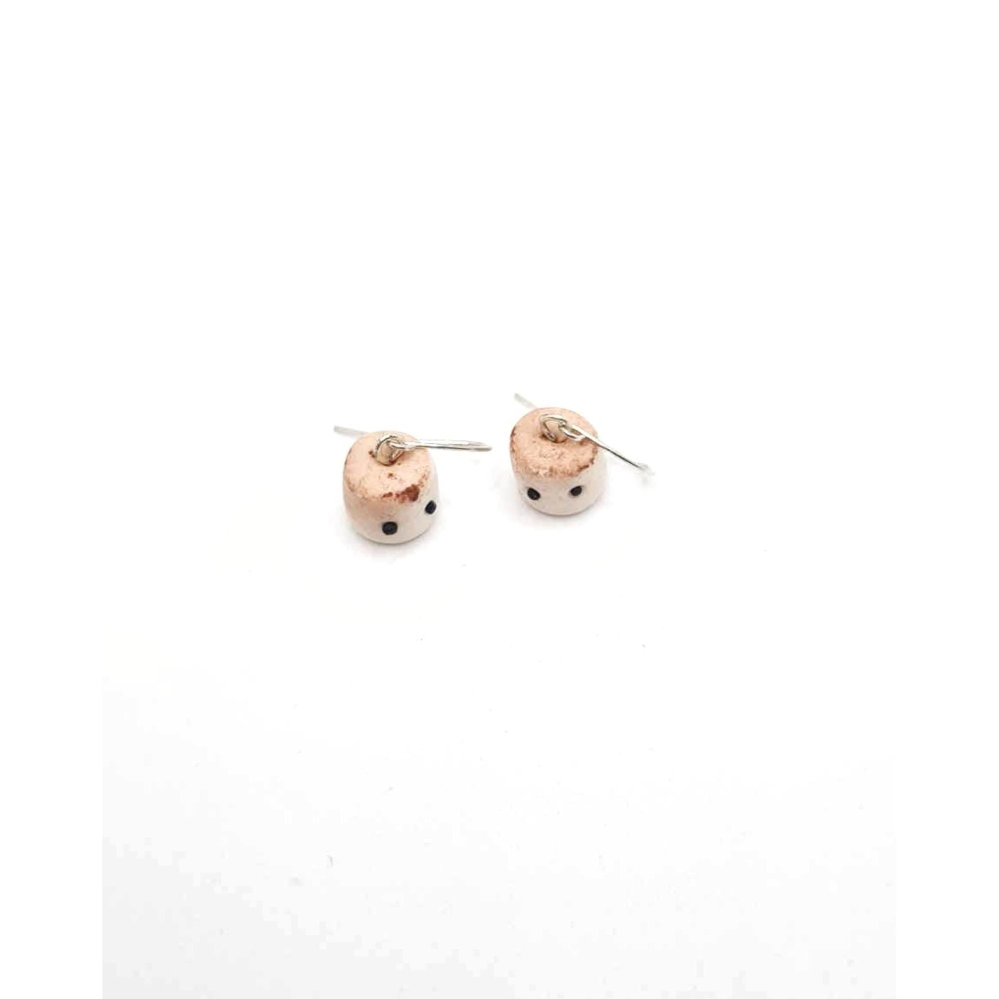 Pair of small round earrings on a white background