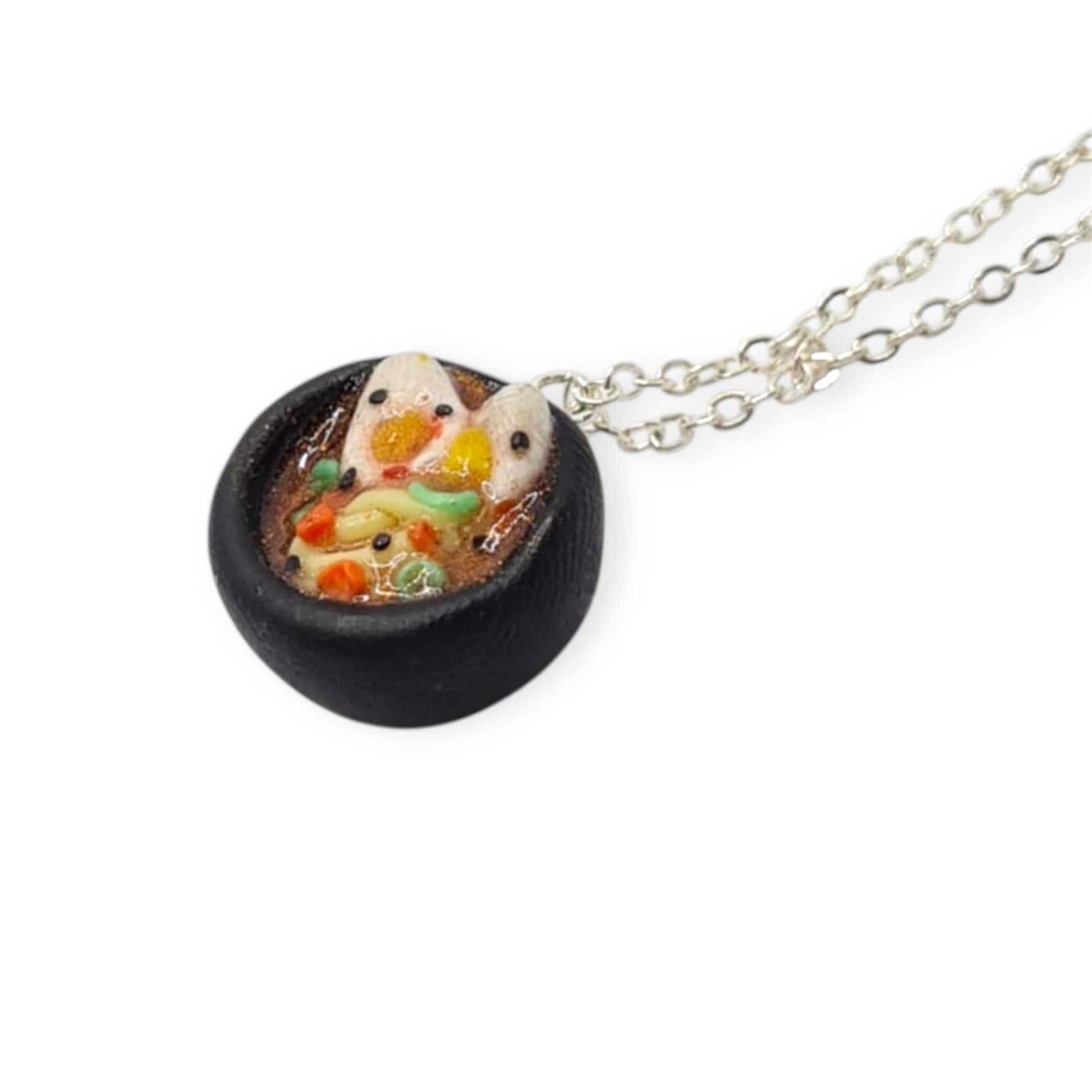 Necklace with a small pendant featuring a ramen bowl on a white background