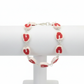 Red and white raw steak bracelet on a white background