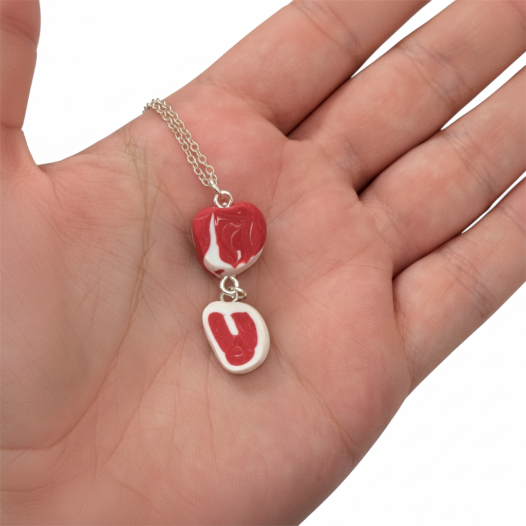 Raw steak necklace displayed on hand 