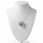 light blue flower pendant necklace with silver chain on a white background