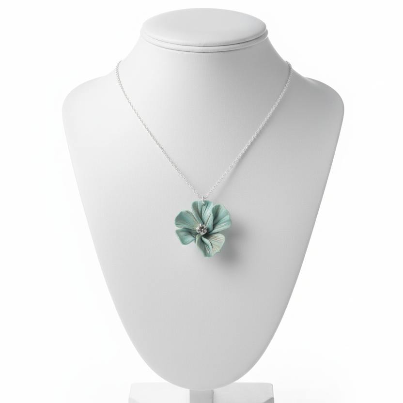 light blue flower pendant necklace with silver chain on a white background