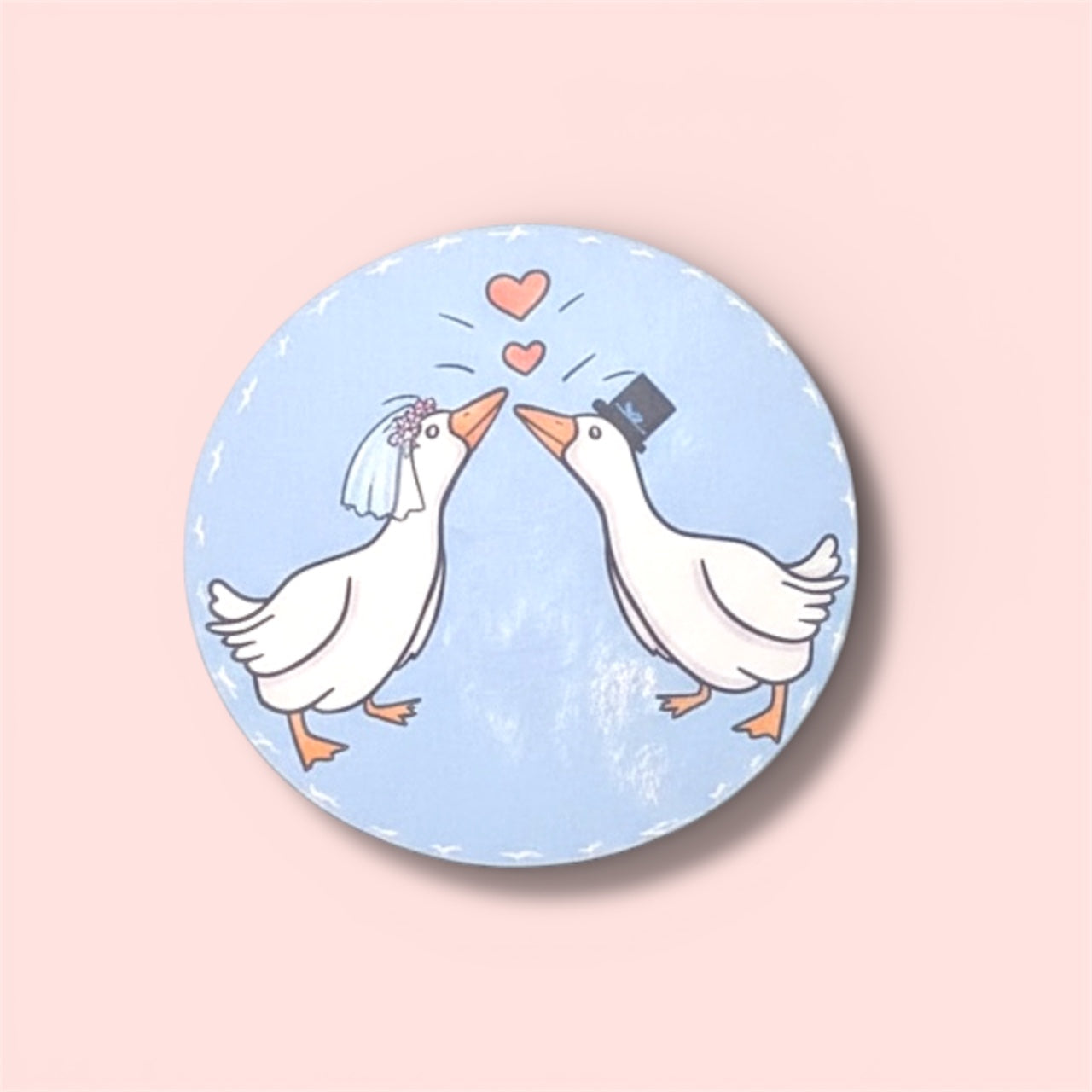 Round sticker with cartoon geese in wedding attire on a light blue background