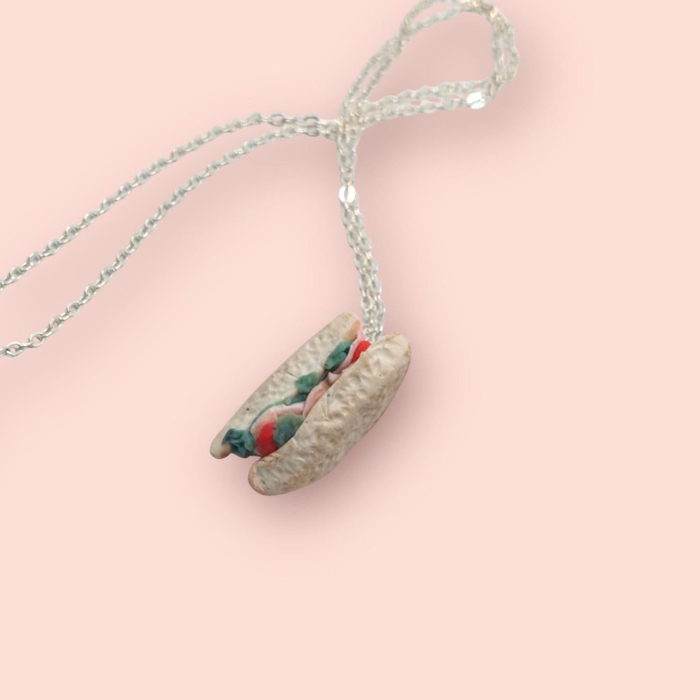 Necklace with a unique pendant on a pink background