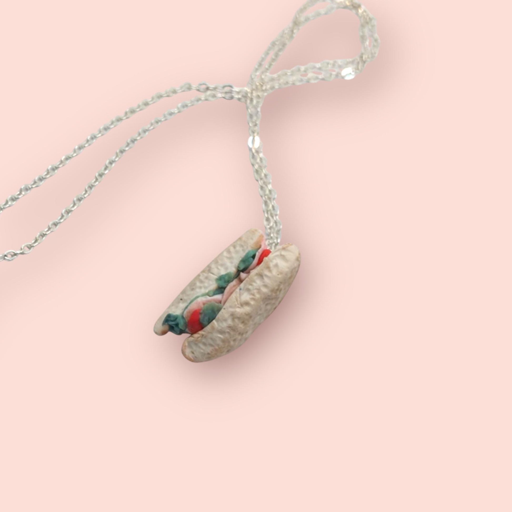 Necklace with a unique pendant on a pink background