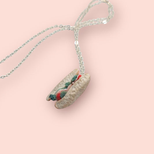 Necklace with a unique pendant on a pink background
