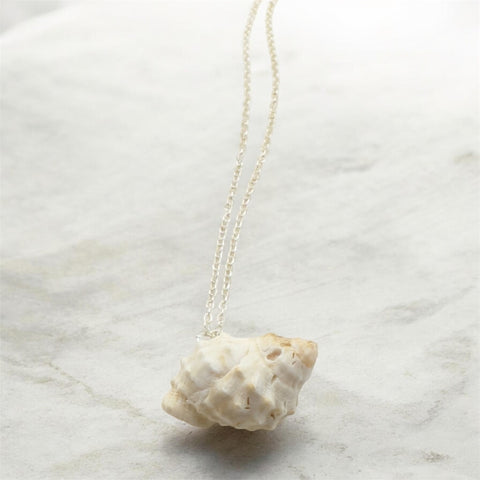 Raw white shell necklace on marble background, handmade by Crystal Seahorse Jewellery