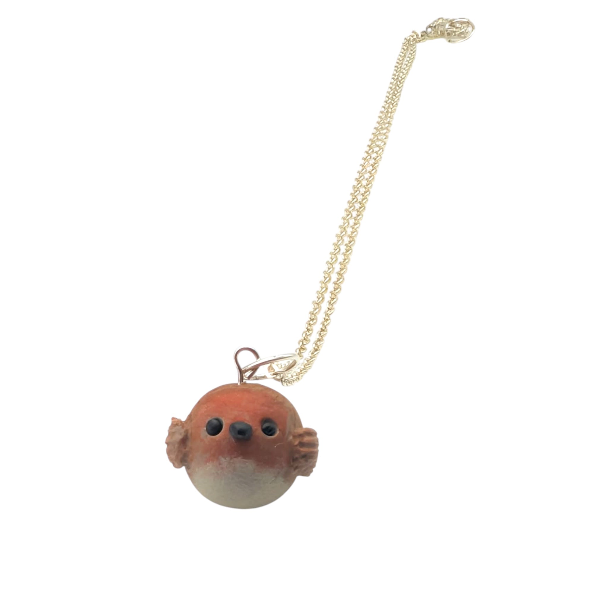 Handmade polymer clay robin pendant on silver chain angled view white background