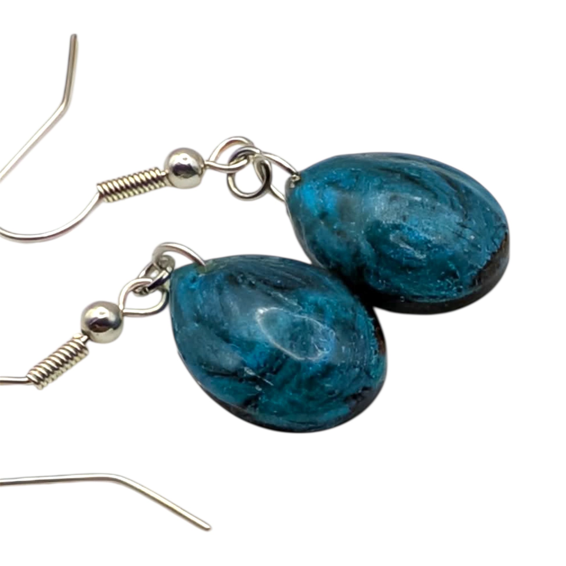 Blue teardrop earrings with silver hooks on a white background