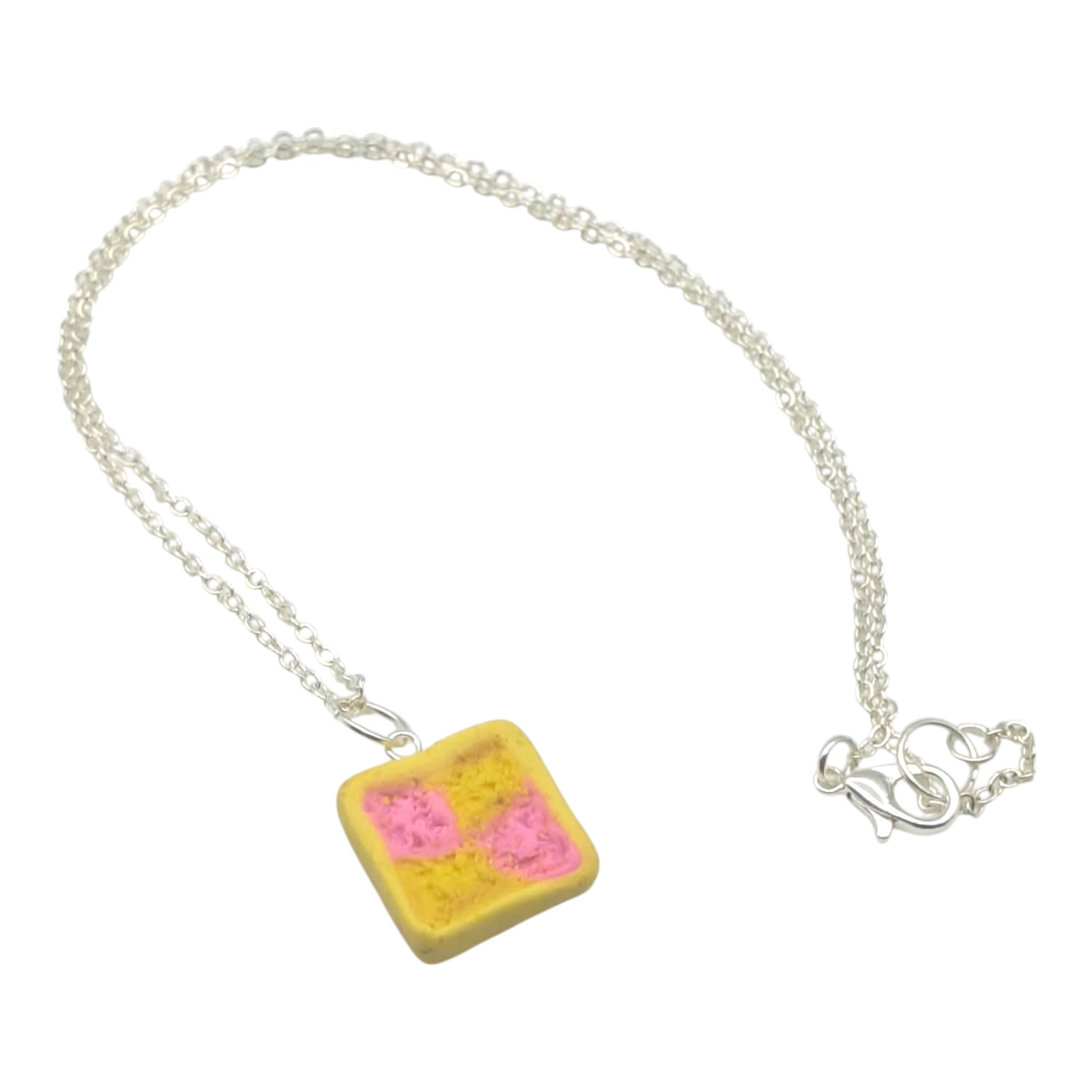 Necklace with a yellow and pink pendant on a white background