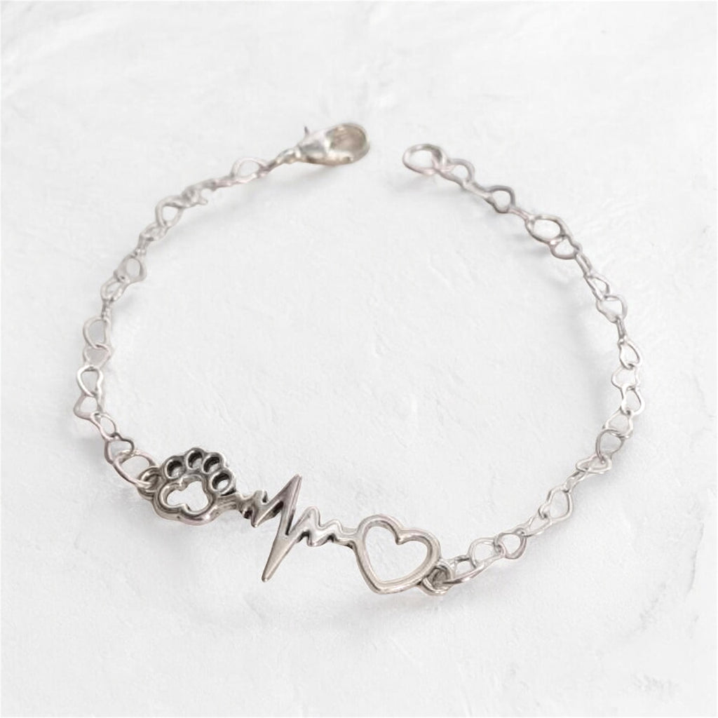 Paw bracelet with heart charm and heartbeat design, perfect jewelry gift for dog lovers.