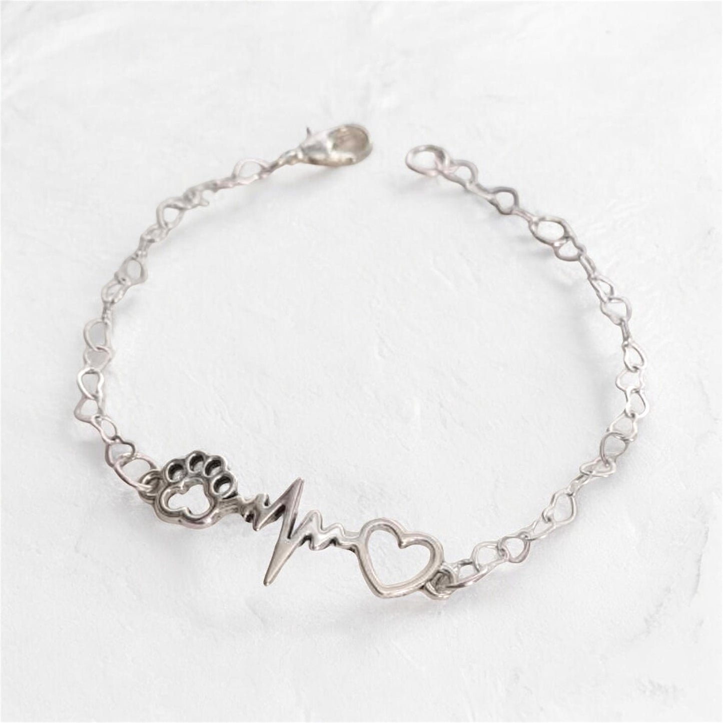 Paw bracelet with heart charm and heartbeat design, perfect jewelry gift for dog lovers.